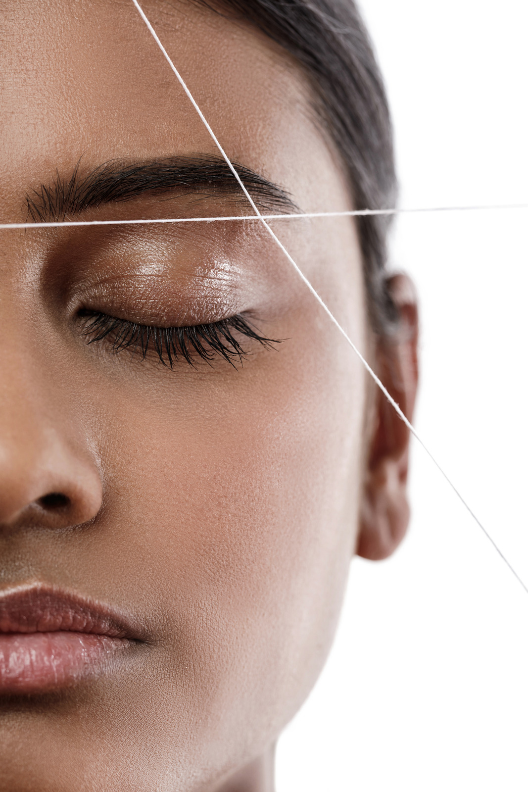 Studio close-up of eyebrow threading